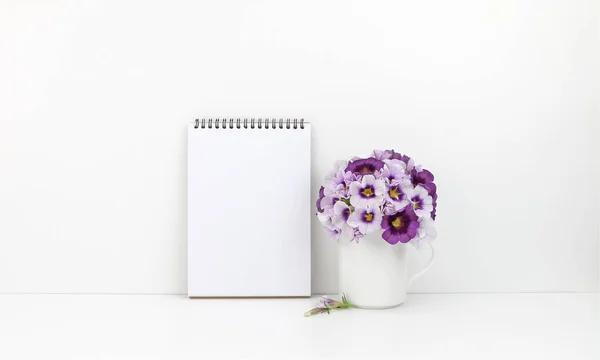 Notepad mockup with flowers and copy space