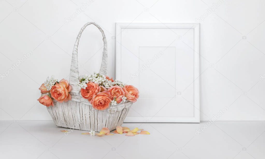 Blank picture frame mockup with a basket of roses, white background