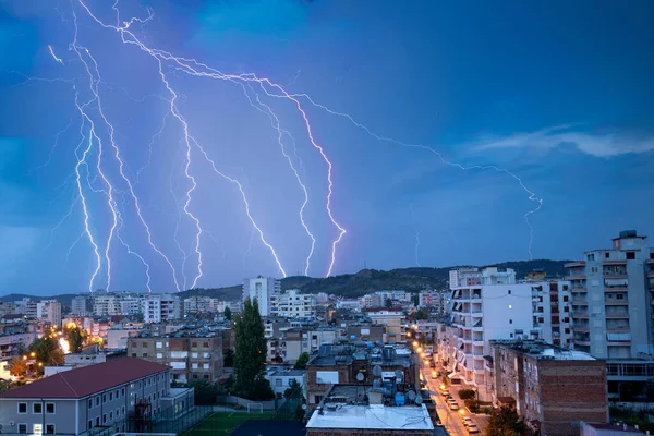 Photo of beautiful powerful lightning over big city, zipper and thunderstorm, abstract background, dark blue sky with bright electrical flash, thunder and thunderbolt, bad weather concept.