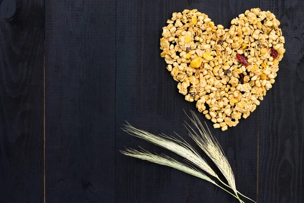 Kalbi tahıl gevreği ve dikenleri siyah ahşap arka planda yatıyordu. Düz yatıyordu. Boşluğu kopyala.