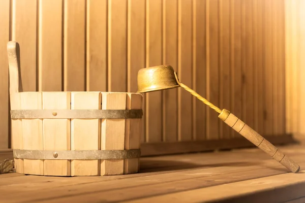 Wooden bucket and ladle in the steam room of the sauna