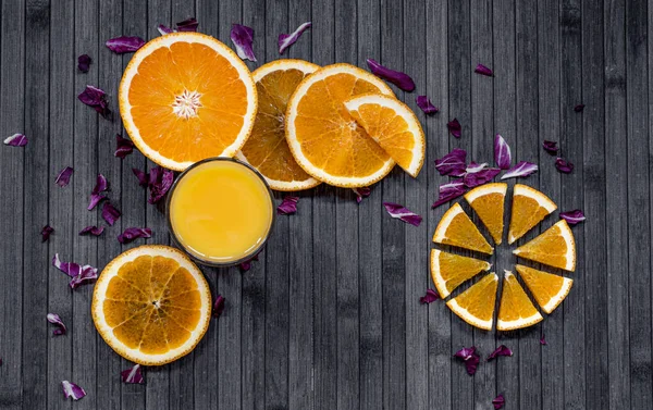 Orange juice. Sliced oranges on dark background.