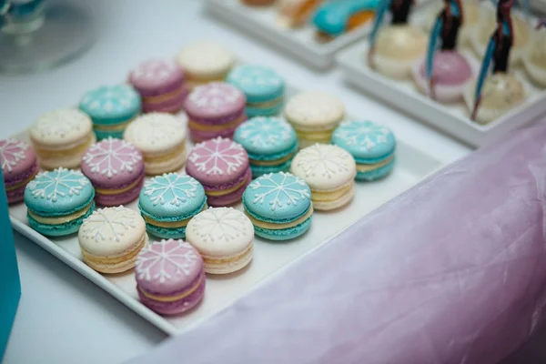 Sweet table. A plates of cakes and muffins with cream. Table with sweets, candy, buffet. Dessert table for a party goodies for the wedding. Close up. candy bar. Decorated delicious