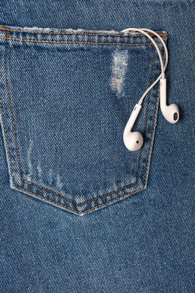 Flat background with copy space. Top view of casual woman outfit, jeans and headphones — Stock Photo, Image