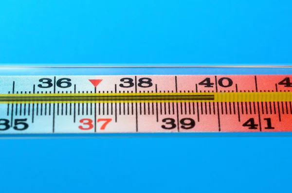 Medical mercury thermometer on a blue background. — Stock Photo, Image