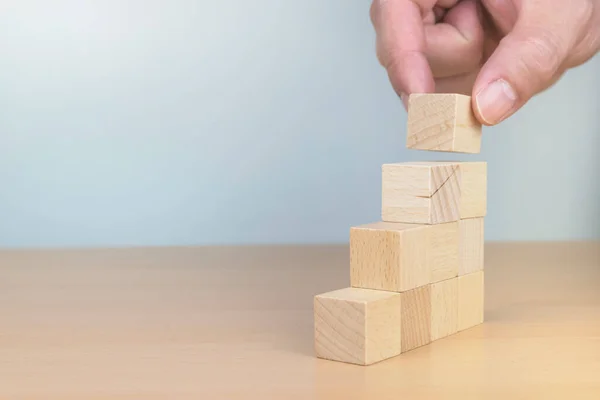 Human resource management and recruitment business concept, Hand flip over wood cube block on top pyramid, Copy space