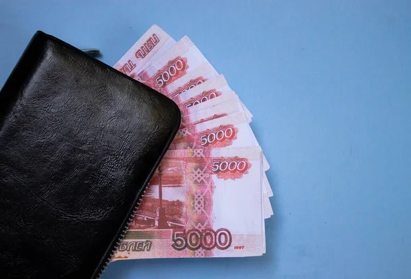 Çalışan adam cüzdanına para koyar. Kirli bir işçinin parmakları, para, sıkı çalışma, cüzdanı olan eller.