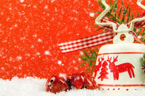 Closeup Christmas Decoration Snow Falling Red Background Jingle Bells Needles — Stock Photo, Image