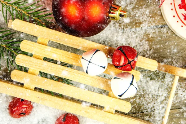 Closeup Christmas Decoration Snow Falling Wooden Background Jingle Bells Needles — Stock Photo, Image