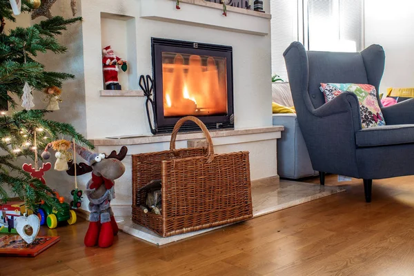 Interior of an house during Christmas time with cosy atmosphere, Christmas decorations and fire place lit