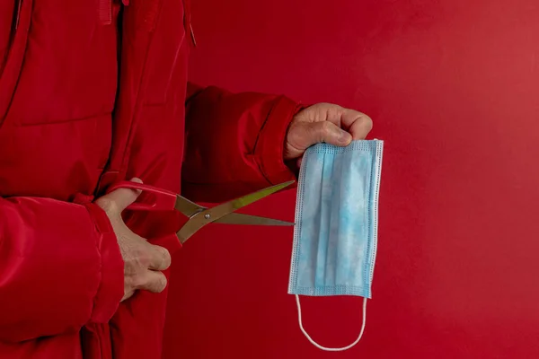 Man Red Jacket Trying Cut Protective Mask Half Corona Virus — Stock Photo, Image