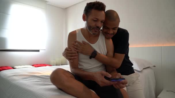 Gay Couple Having Fun Mobile Phone Bed — Stock Video