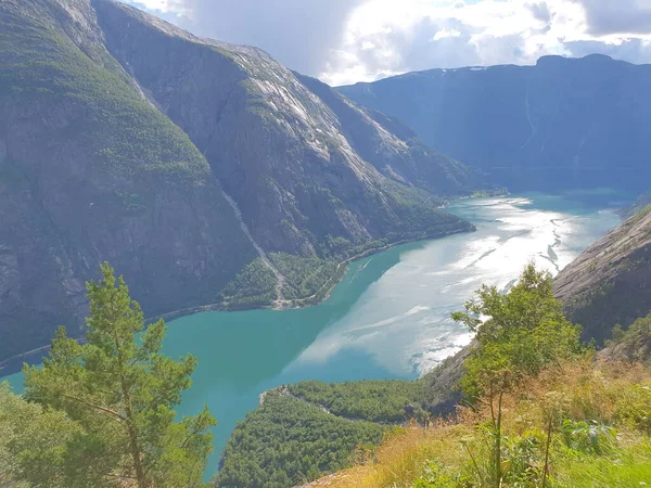 Gökyüzü, dağlar ve fiyort manzaralı bir manzara.