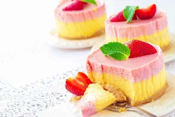Delicious homemade mango strawberry cheesecake white background Copy space Selective focus.