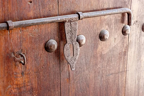 Old wooden door with vintage metal decoration latch. Arabian style.