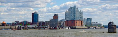 panoramic view across the river Elbe to the harbour city with the building of the Elbphilharmonie at Hamburg, Germany clipart