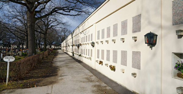 Wall with graves for cinerary urns at the Viennese central cemetery in sunshine, Austria