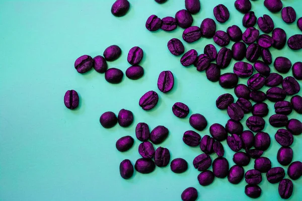 purple coffee beans on a teal background