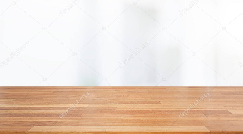 A beautiful empty wood board  with white blur glass window wall building background .For montage product display or design key visual layout background.