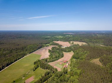 Drone görüntü. alanları ve bulutlu bahar günü ormanlarda kırsal alan hava görünümünü. Letonya