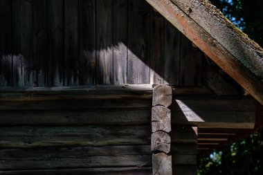 Eski ahşap Letonya kırsal kesimde yaz yeşillik ile binanın terk edilmiş kalıntıları