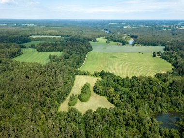 Drone görüntü. alanları ve bulutlu bahar günü ormanlarda kırsal alan hava görünümünü. Letonya