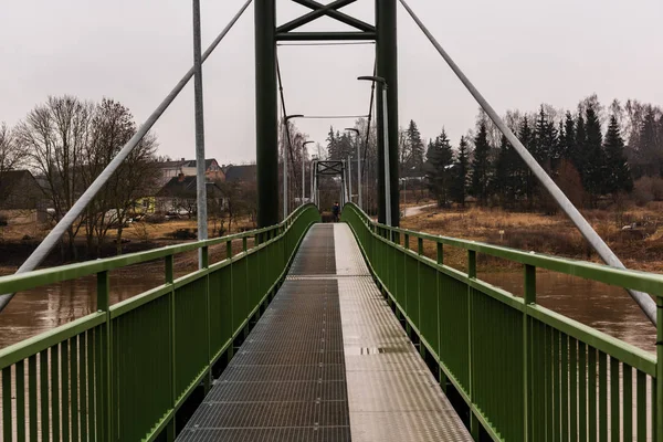 metal pedestrian bridge details in city of Bauska, Latvia. abstract texture and lines in cloudy spring day