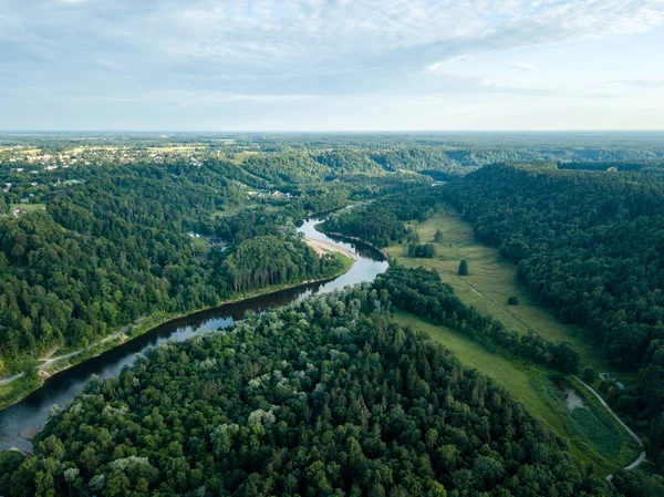 drone image. aerial view of forests and river Gauja in the middle in summer day. Latvia, Sigulda municipality.