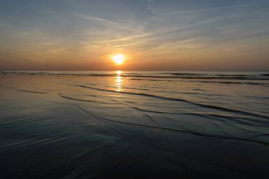 Güzel günbatımı yoğun bulutlar ve küçük dalgalar ile Baltık Denizi
