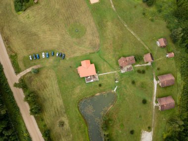 drone görüntü. alanları ve ormanları ile kırsal alan hava görünümünü. kamp konut çatılarının. Letonya