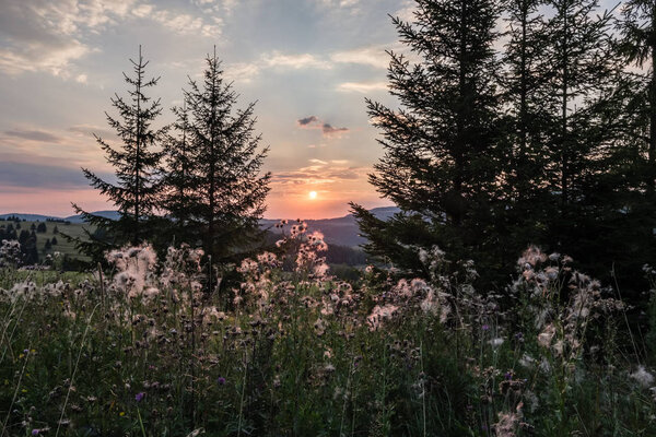 beautiful sunset in the mountains of Tatra, slovakia. hill tops with red clouds over them.  Western carpathian