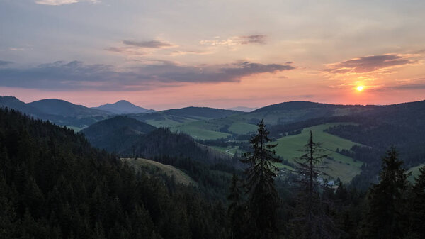 beautiful sunset in the mountains of Tatra, slovakia. hill tops with red clouds over them.  Western carpathian