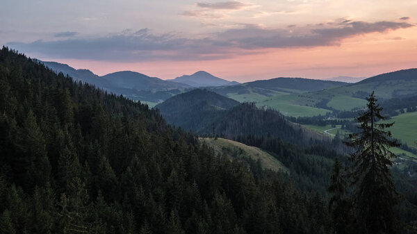 beautiful sunset in the mountains of Tatra, slovakia. hill tops with red clouds over them.  Western carpathian