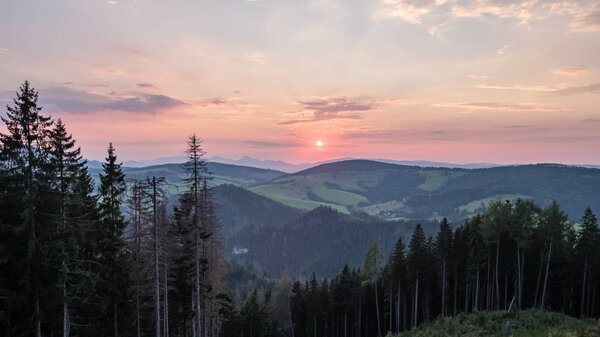 beautiful sunset in the mountains of Tatra, slovakia. hill tops with red clouds over them.  Western carpathian