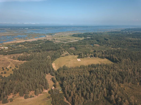 aerial view of rural area with fields and forests at daytime