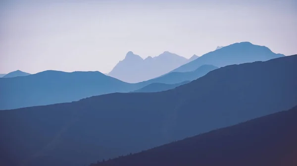 western Carpathian mountain tops in autumn covered in mist or clouds