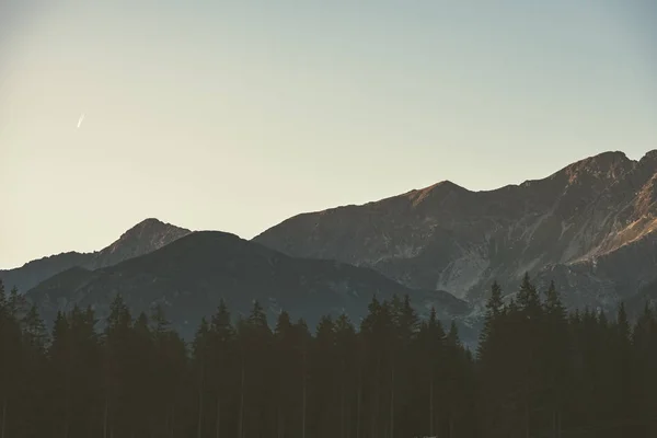 morning light rising over hill tops and forests in mountains Tatra in Slovakia