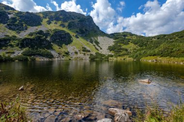 dağ Gölü geç yaz aylarında Slovakça Karpat Tatra'panorama görünümünü su kayalık tepede yansımaları ile. Zverovka köyü yakınındaki Rohacske plesa göller.