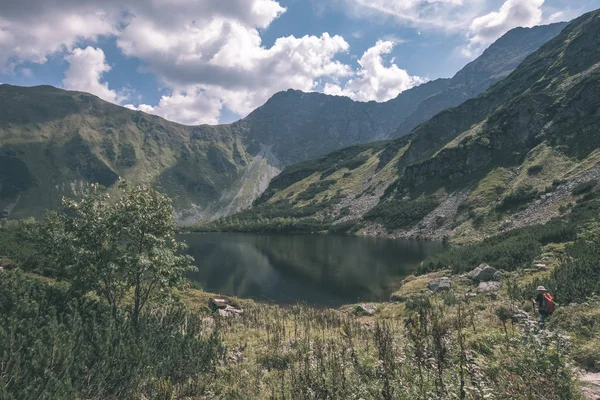 beautiful mountain lake panorama view in late summer in Slovakian Carpathian Tatra mountains with reflections of rocky hills in water. Rohacske plesa lakes near Zverovka village