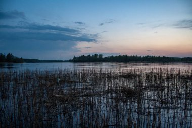 renkli gün batımı göl su yansımaları ve dramatik fırtına bulutları yukarıdaki ile yukarıda. geç akşam renkleri
