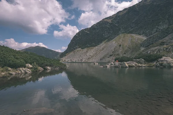 beautiful mountain lake panorama view in late summer in Slovakian Carpathian Tatra mountains with reflections of rocky hills in water. Rohacske plesa lakes near Zverovka village