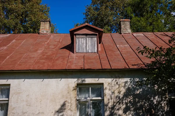 country house roof top with chimney on blue sky background