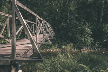 su yeşil yaz orman çevresinde göl - vintage bir retro görünüm ile ahşap ve kompozit malzeme ayak köprüden