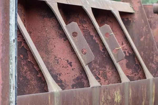 old red metal bridge over water. rusty details and close ups