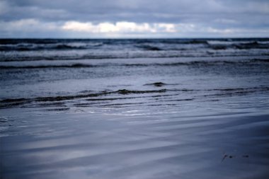deniz üzerinde fırtına bulutları. temiz beyaz kum plaj üzerinde küçük dalgalar. sığ derinlik-in tarla