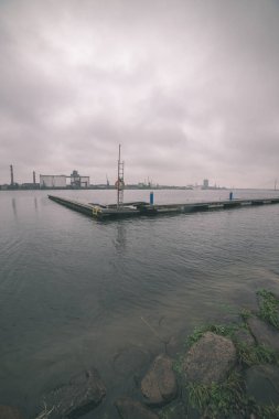 arka plan üzerinde endüstriyel bölge ile deniz manzaralı