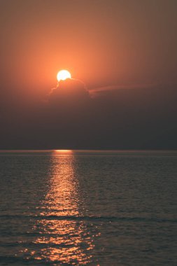 renkli dramatik turuncu günbatımı sakin deniz üzerinde dramatik gökyüzü ile yaz aylarında