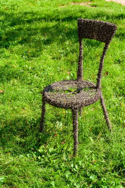 barber wire chair in green meadow