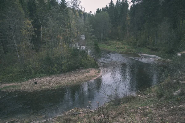 rocky forest Amata river with low stream in summer, Latvia