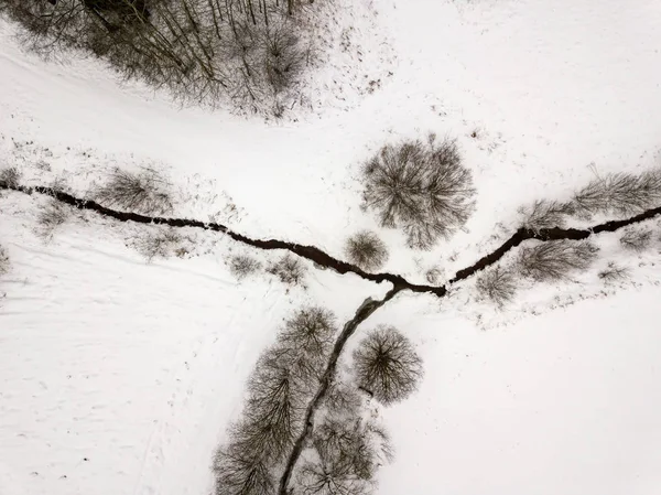 country small river lines in field in winter